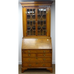  19th century oak and mahogany banded bureau bookcase, projecting cornice, dentil frieze, astragal glazed doors, three adjustable shelves above fall front enclosing fitted interior, three long and two short drawers, shaped bracket supports, W108cm, H220cm, D57cm  
