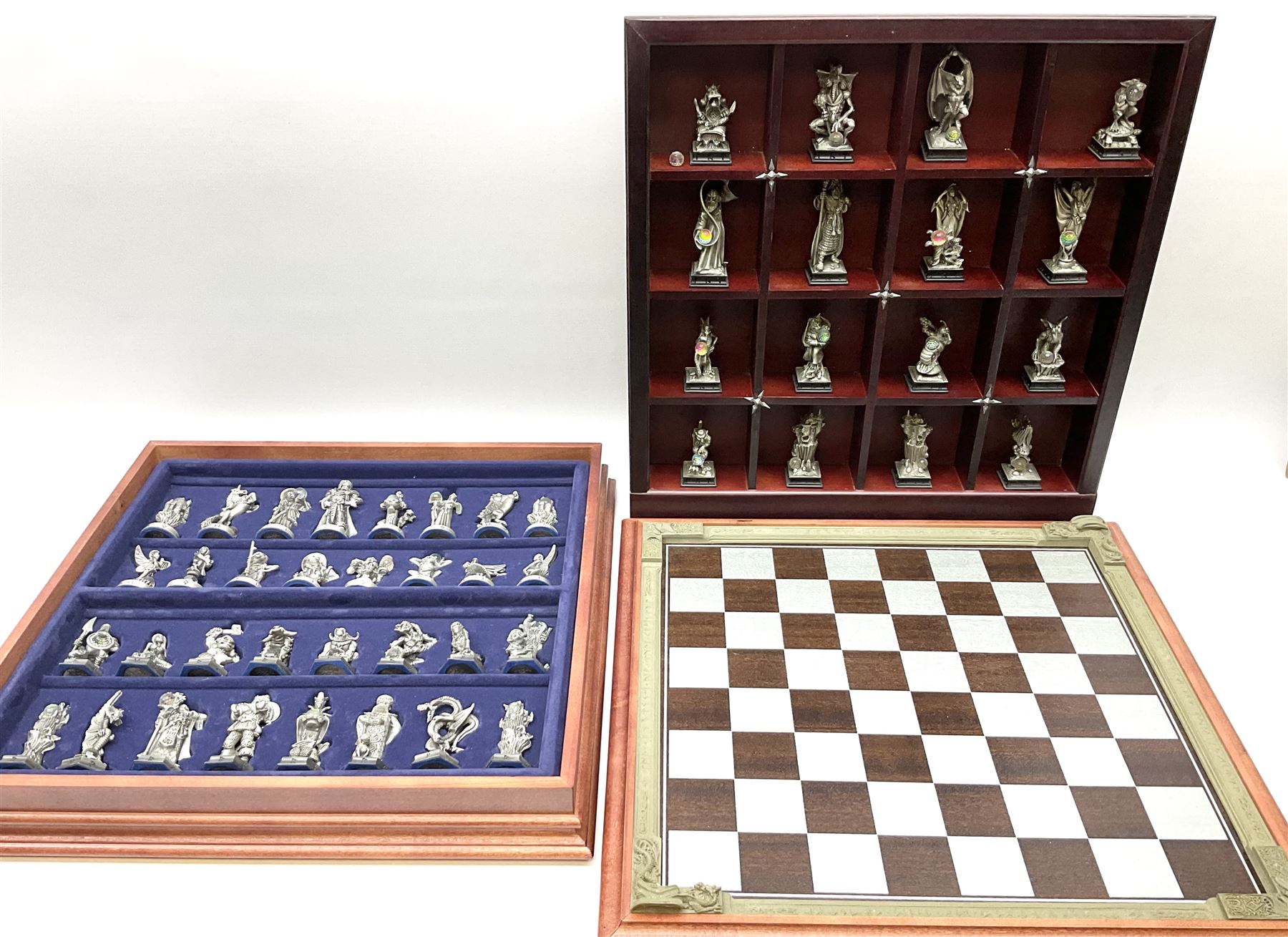 Danbury Mint 'The Fantasy of the Crystal' chess set consisting of mythical pewter chess pieces within a wooden case with chess board lid, together with 16 additional chess pieces in a wooden display case.