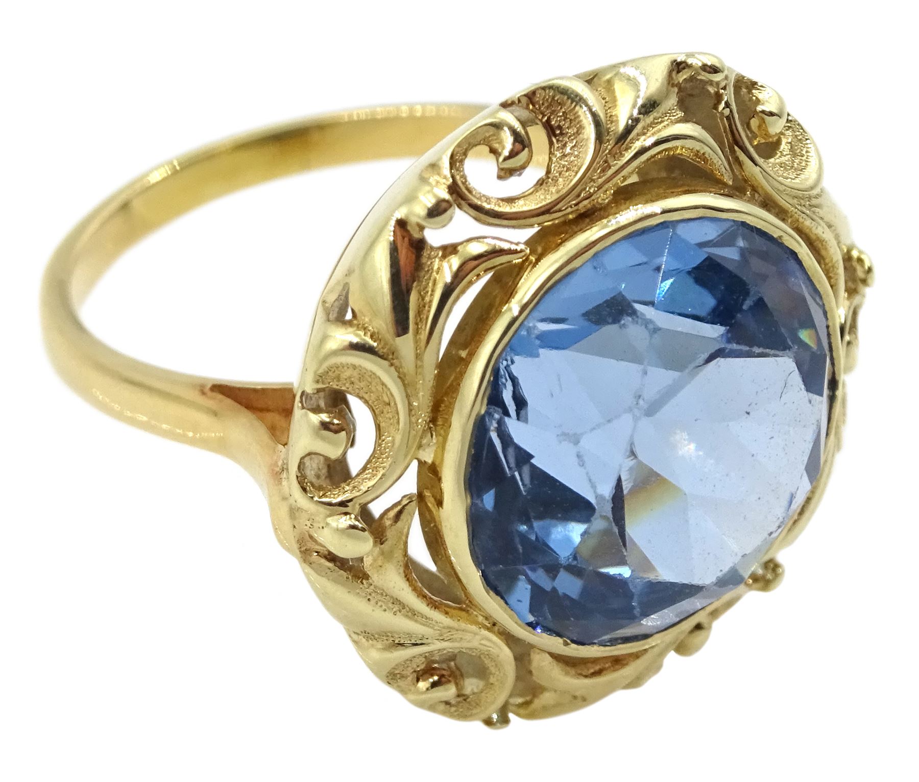 18ct gold single stone round synthetic blue spinel ring, with pierced leaf border