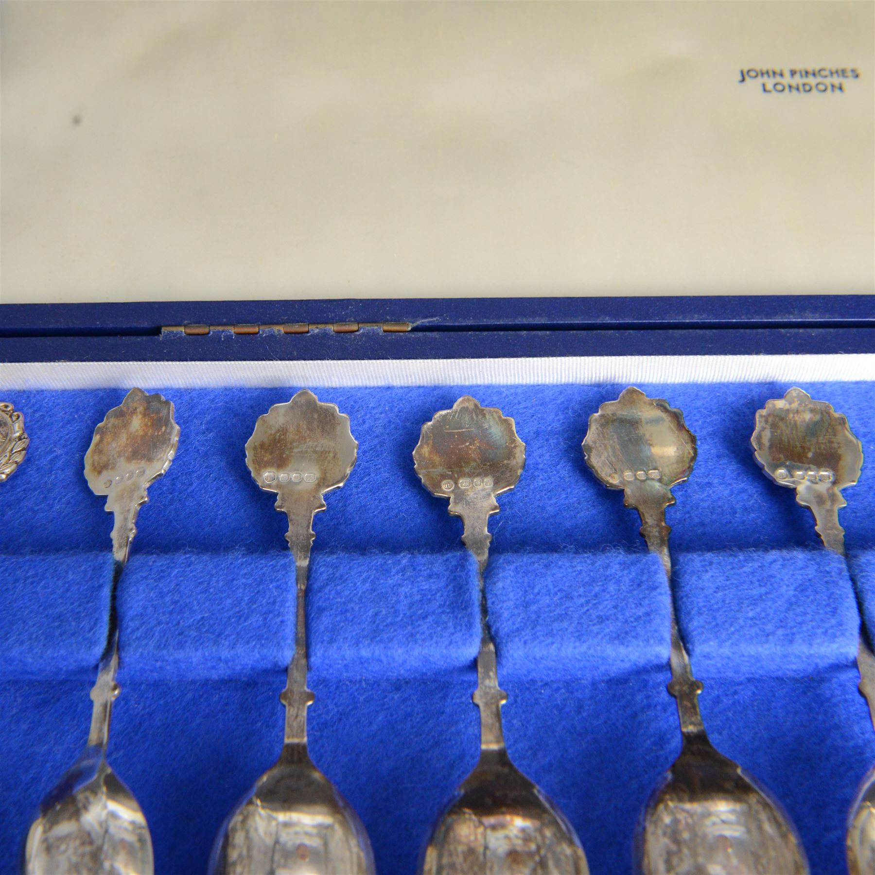 Set of twelve modern silver teaspoons 'The Twelve Zodiac Spoons', all decorated with symbols of the zodiac, hallmarked John Pinches, London 1971, contained within fitted case
