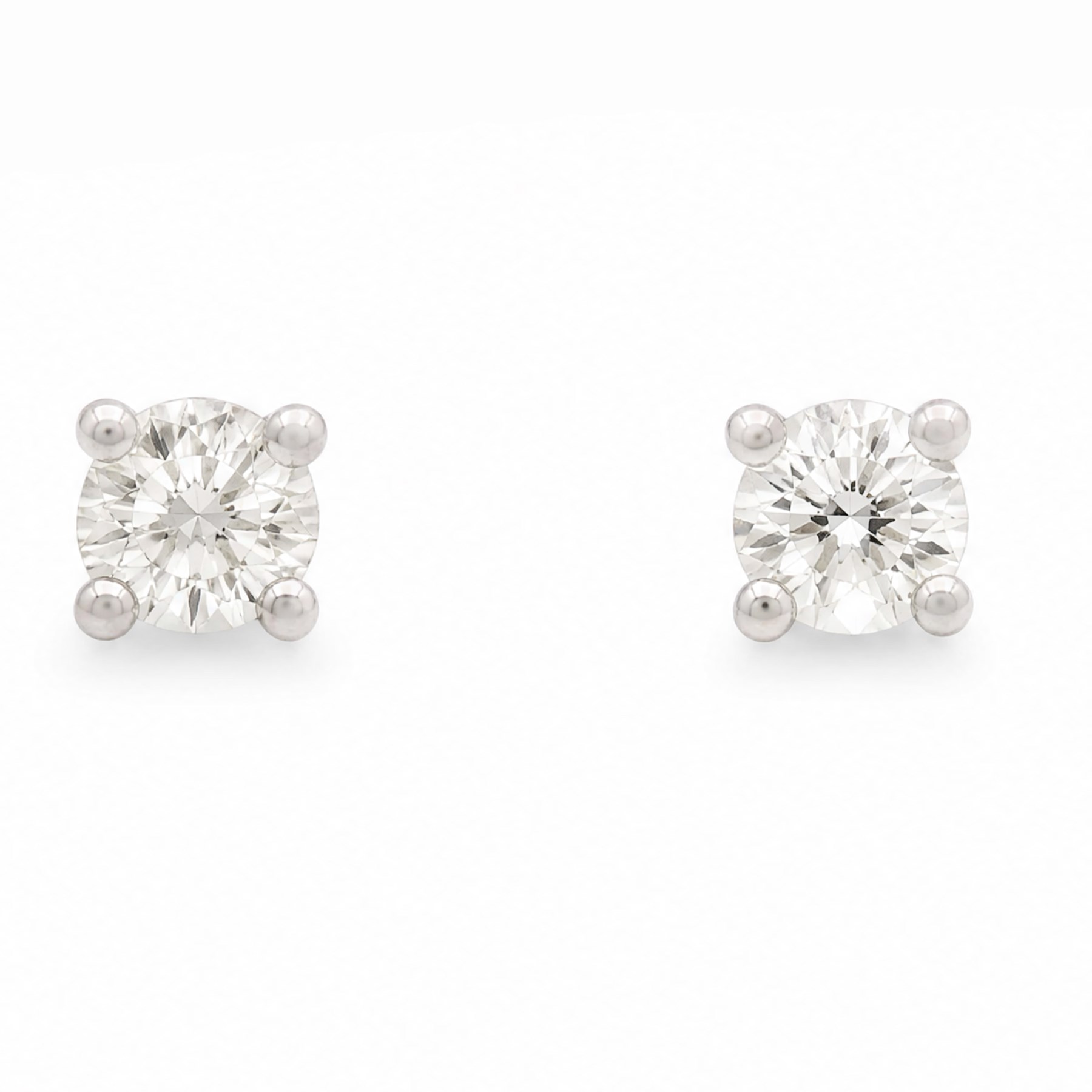 Pair of platinum diamond earrings, each stud four claw set with a single round brilliant cut diamond, stamped Pt 950, total diamond weight approx 0.55 carat