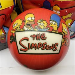 Two The Simpsons 'The Bowling Club' tenpin bowling balls, the first an undrilled example depicting Bart Simpson on a green ground, the second a drilled example depicting the Simpsons family on an orange ground, both in Simpsons The Bowling Club bags, together with a Disney Monsters, Inc. tenpin bowling ball, in matching bag and a Maxim tenpin bowling ball