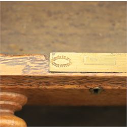 20th century oak compact pedestal desk, tooled green leather inset top, above a single frieze drawer, with a bank of four graduated drawers and a drawer and cupboard, panelled sides raised on castors