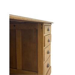 Early 20th century oak twin pedestal partners desk, the moulded rectangular top with inset leather, each side fitted with four drawers and cupboard with panelled door, plinth base

