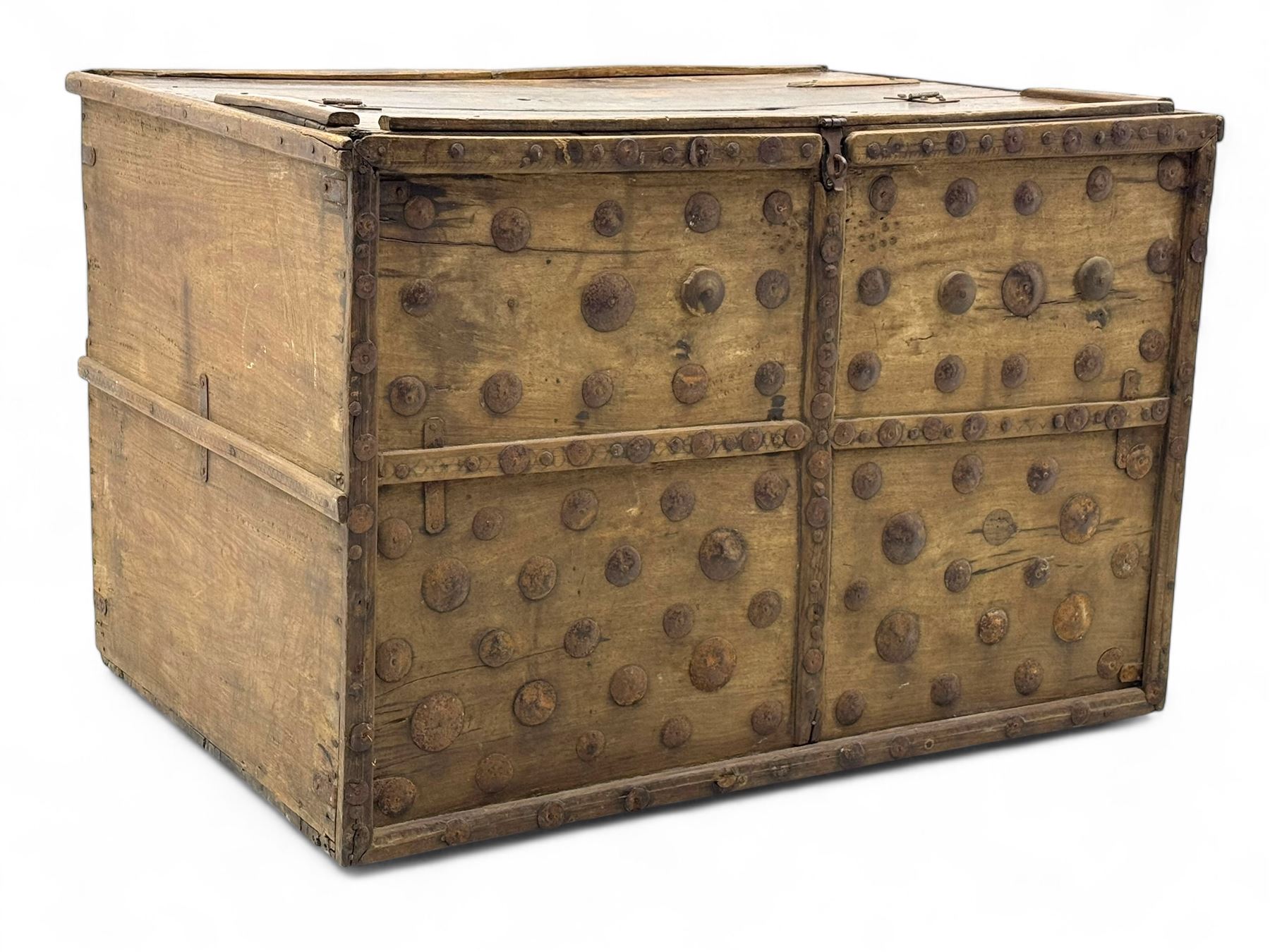 Late 19th century Afghan carved hardwood storage chest, the hinged plank top enclosing large internal storage space, geometric carvings to the front panels decorated with rows of riveted iron bosses