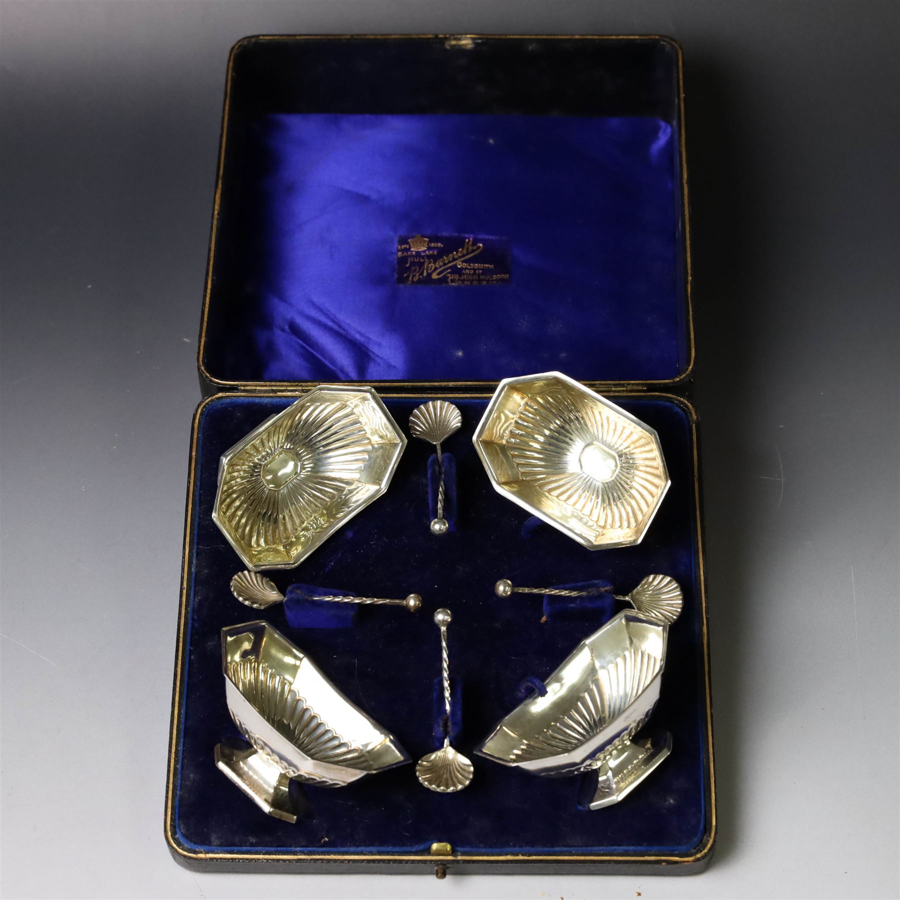 Set of four late Victorian silver open salts, of octagonal part fluted form, with four clam shell spoons, hallmarked Colen Hewer Cheshire, Birmingham 1896, salts H4cm, contained within fitted case