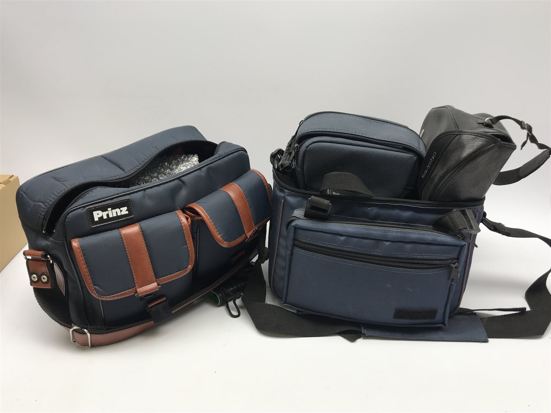 PENTAX program A camera body with RMC Tokina 28mm 1:2.8 lens, RMC Tokina 80-200mm 1:4 lens, RMC Tokina doubler for P/K, Tokina 35-70mm 1:3.5-4.8 lens, OLYMPUS OM 30 camera body with OLYMPUS OM-SYSTEM 50mm 1:1.8 lens, Miranda 28-70mm 1:3.8-4.8 MC macro lens, Makinon MC Zoom1:4.5 80-200mm lens, Minolta X-370s camera body with Minolta MC Rokkor-PF 1:17 lens, two Olympus cameras, Minolta AF Zoom 35-105mm lens, Minolta MAXXUM AF zoom 100-300mm lens, 