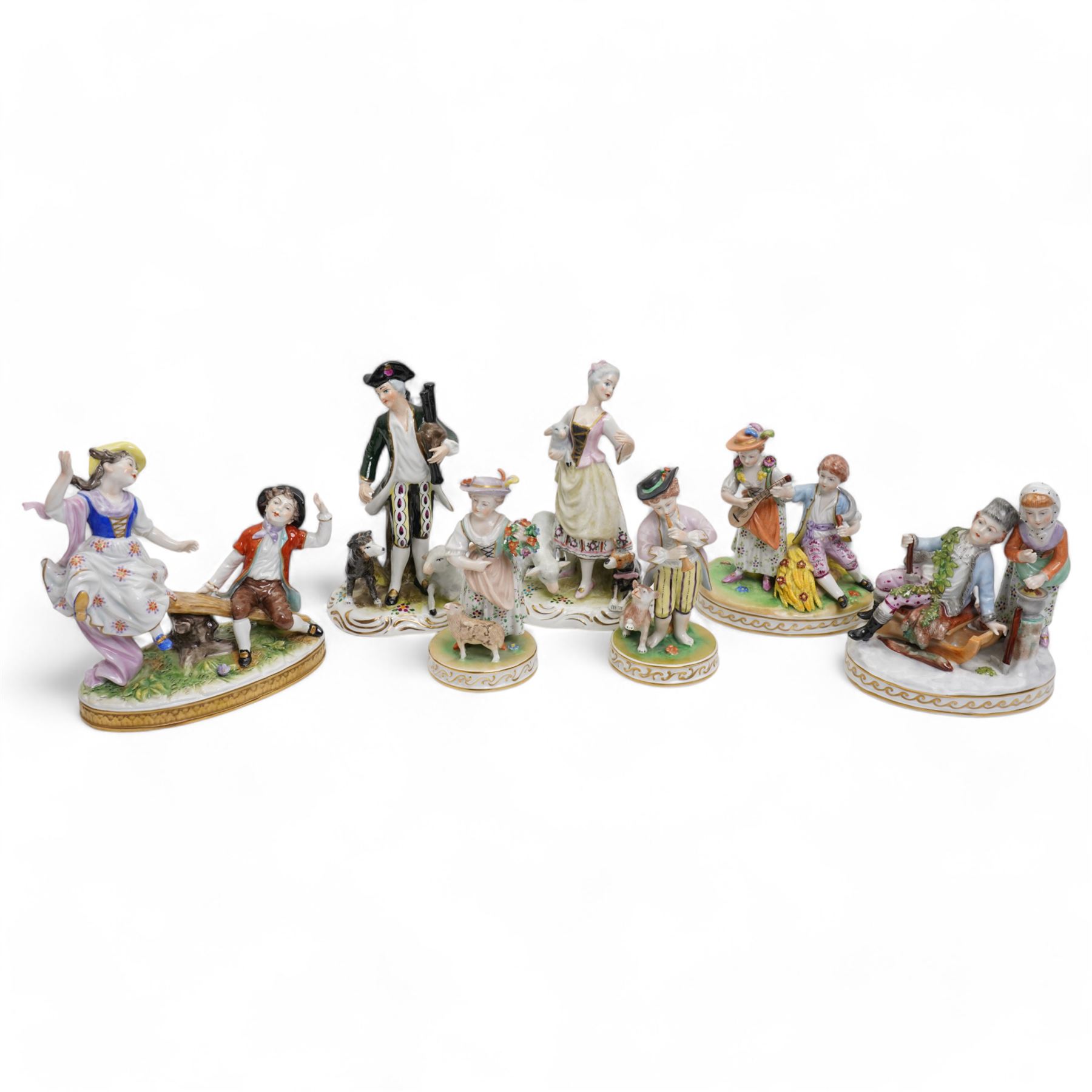 Group of four Dresden figures, including a boy playing the flute, a lady and her lamb, a couple and their sleigh, and a lady playing a mandolin H14cm; together with three other German figures, including a courting couple, largest H18cm (7)