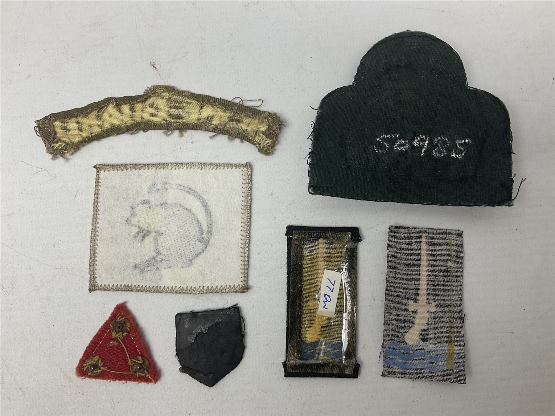 Royal Arms cloth arm adge as worn by Regimental Serjeant-Majors in Foot Guards; naval cap badge; WW2 Commando/Special Forces cloth badges; Home Guard and LDV shoulder titles; and other cloth badges including armoured division, 45th and 77th division, 52nd Lowland Mountain division etc; and 24th Infantry Brigade airmobile pennant