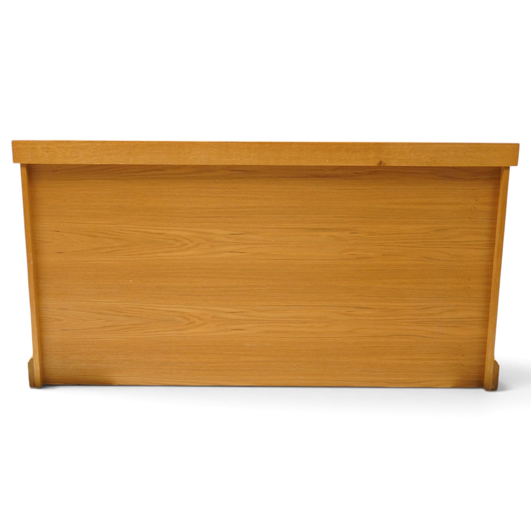 Unicornman - craftsman made oak low-cupboard or sideboard, rectangular top with raised back, fitted with four panelled cupboard doors, on skirted base applied with carved unicorn signature, by Geoff Gell of Coxwold