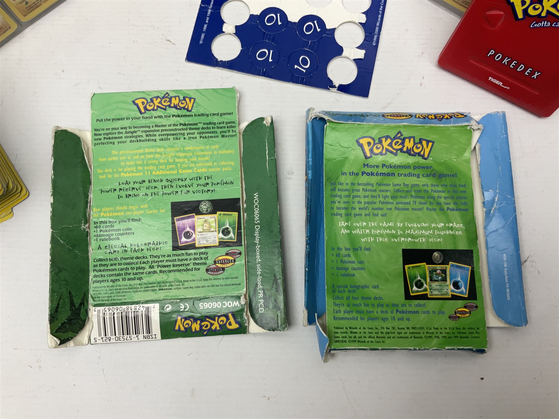 Collection of Pokemon trading cards, mostly 1999 Wizards Pokemon cards to include holo Charizard 4/102, first edition holo Machamp 8/102, further holographic cards; Dark Flareon 35/82 and Dark Vaporeon 45/82, cards from themed sets and 4th edition prints; 1998 Electronic Pokédex with cardboard boxes for themed decks Blackout, Overgrowth and Power Reserve Jungle, along with a large quantity of energy and trainer cards 