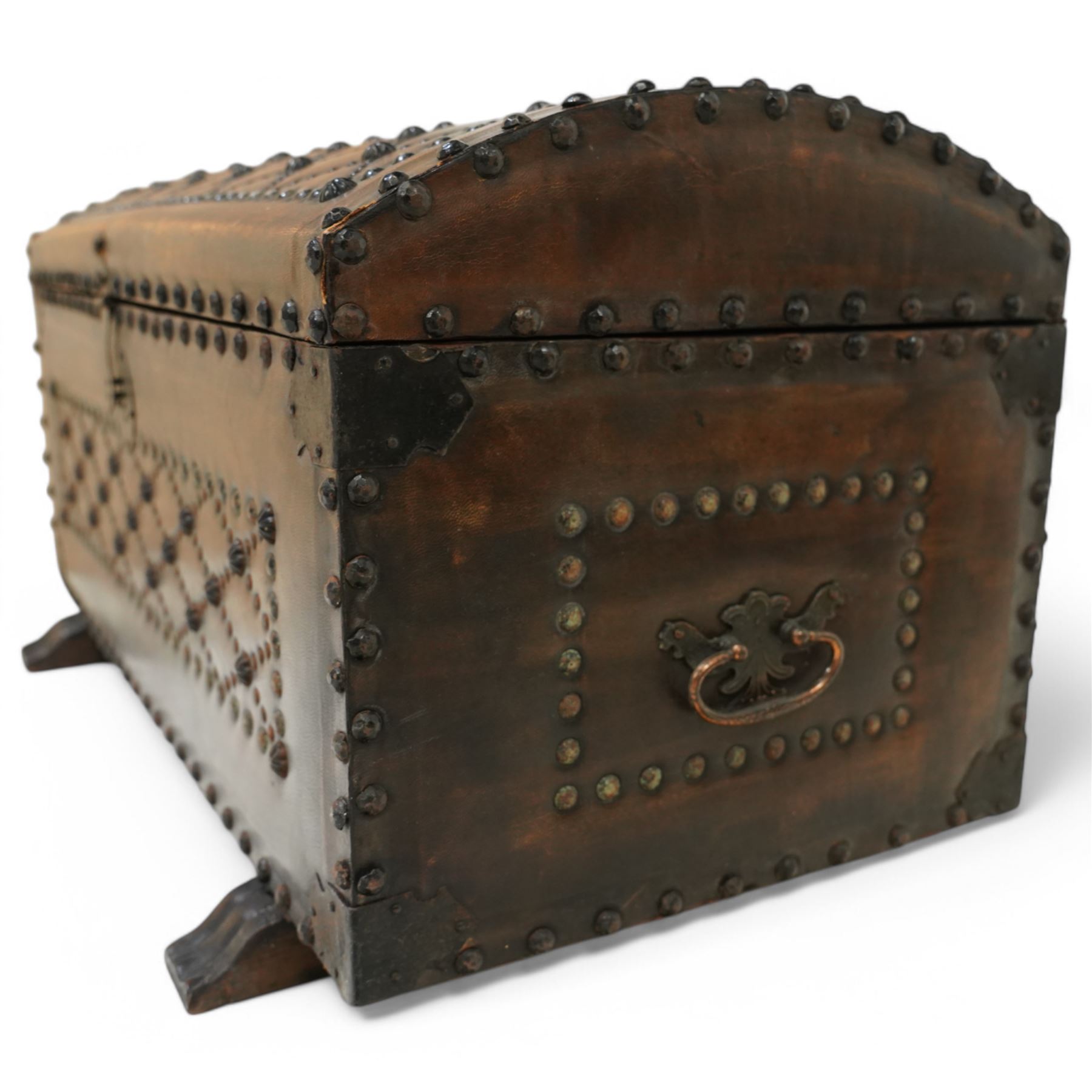 Studded leather dome top trunk, the hinged lid and front decorated with cross pattern in studs, on sledge feet 