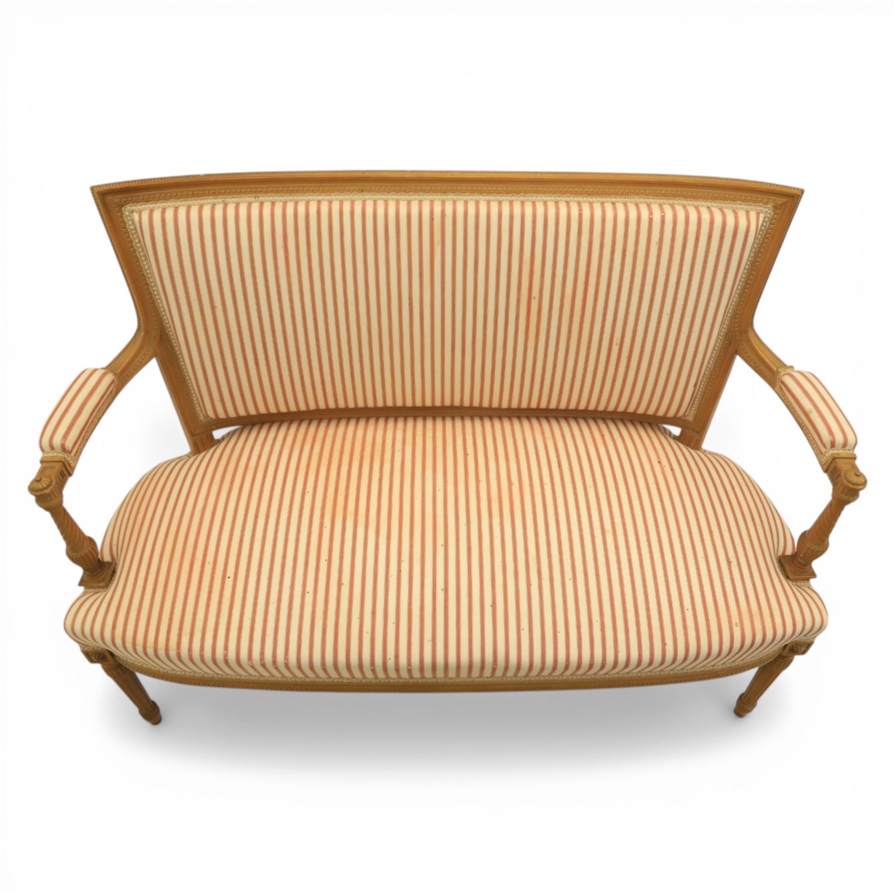 20th century Louis XVI style beech salon suite, comprising settee and four chairs, the settee with shaped rectangular back and upholstered arms over a shaped seat, the chairs with rectangular backs and overstuffed seats, each upholstered in striped fabric with close-nailed borders, upon fluted tapering supports headed by carved paterae, terminating in toupie feet, chairs H89cm W47cm
