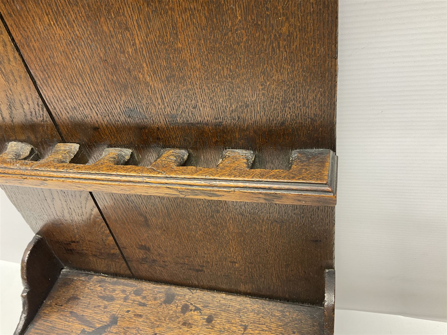 George III oak spoon rack and candle box, the rectangular backplate with shaped  pediment and two six aperture spoon racks, above a candlebox with hinged cover, with various brass spoons and a pair of brass candle snuffers, H56.5cm, W35cm, D14cm 