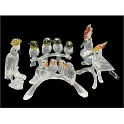  Four Swarovski Crystal bird figures, comprising Cockatoo, pair of Hoopoes on a branch, four Lovebirds on a branch and four Hummingbirds on a branch, largest H10cm