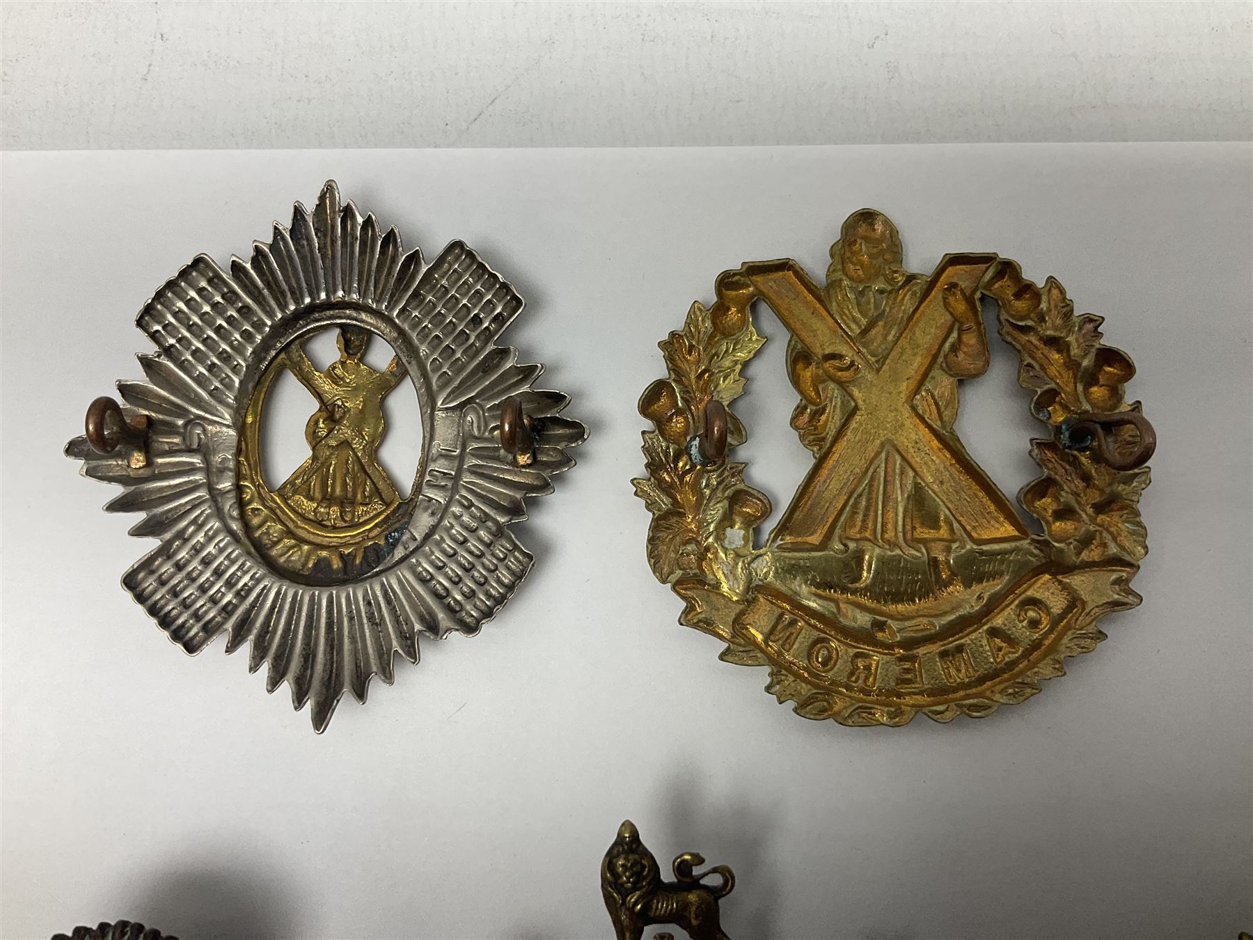 Fifteen Scottish Glengarry and other metal military badges including Argyll & Sutherland, Royal Glasgow Yeomanry, Cameronians, Lanarkshire Yeomanry, Kings Scottish Own Borderers, Highland Light Infantry, Border Regiment, Lowland Regiment, Lothians & Border Horse Yeomanry, Ayrshire Earl of Carricks Own Yeomanry etc