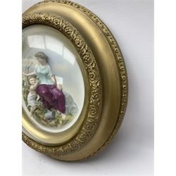 Set of four early 20th century Continental bisque plaques, each of circular form, modelled in high relief as the Four Seasons personified, within gilded circular frames under convex glass, overall D44.5cm