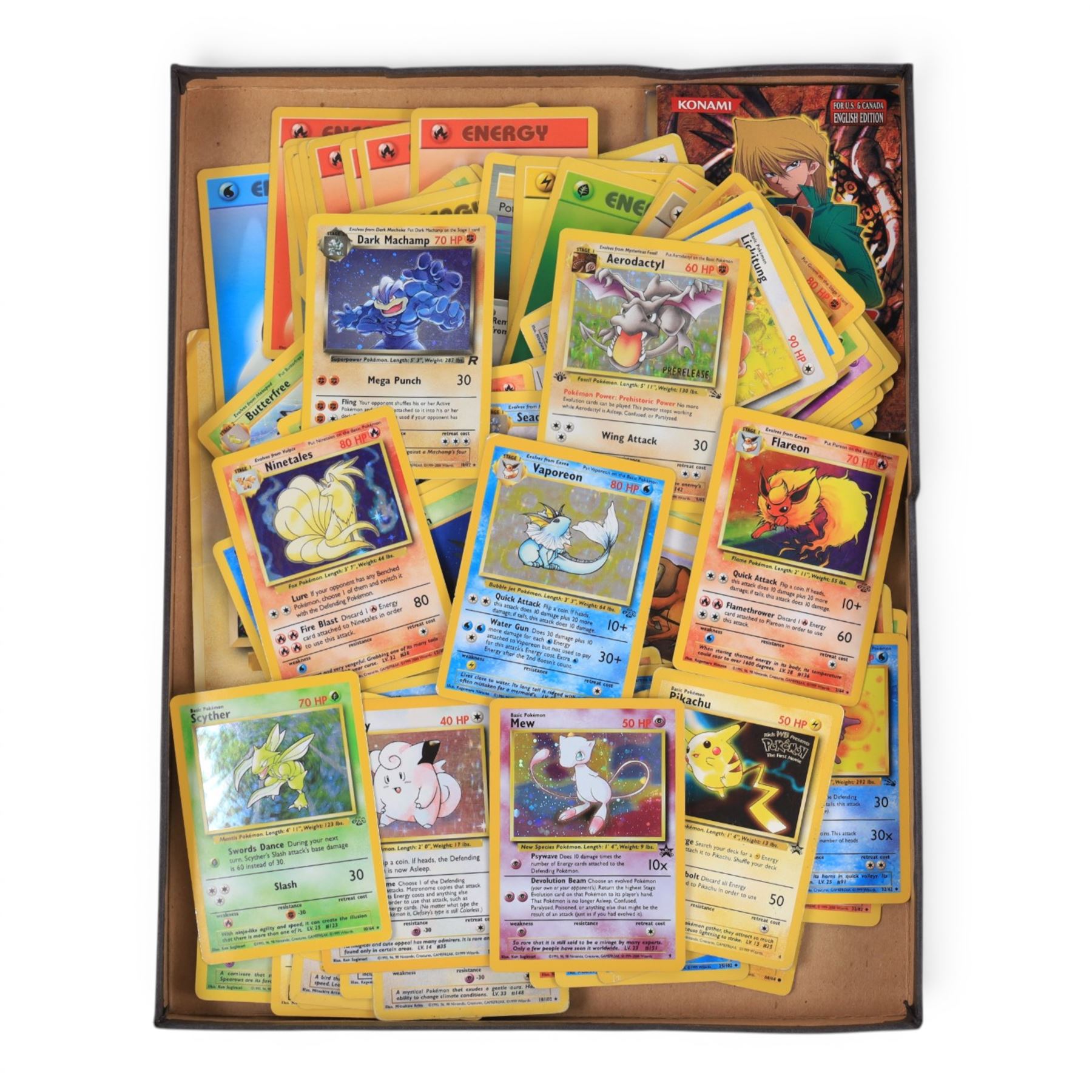 Collection of  Wizards Of The Coast Pokemon trading cards including Base Set, Jungle Set, Fossil Set and Team Rocket examples, black star promo Mew, Arcanine and Pikachu, holo Ninetales and Clefairy, 1st edition pre-release holo Aerodactyl, Team Rocket Dark Machamp holo and Jungle set Flareon, Vaporeon and Scyther holos 