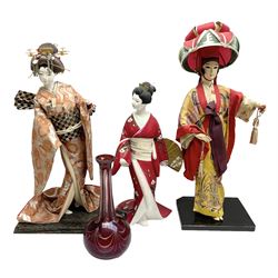 Three Japanese Geisha dolls figures, cut glass cranberry decanter (lacking lid) etc
