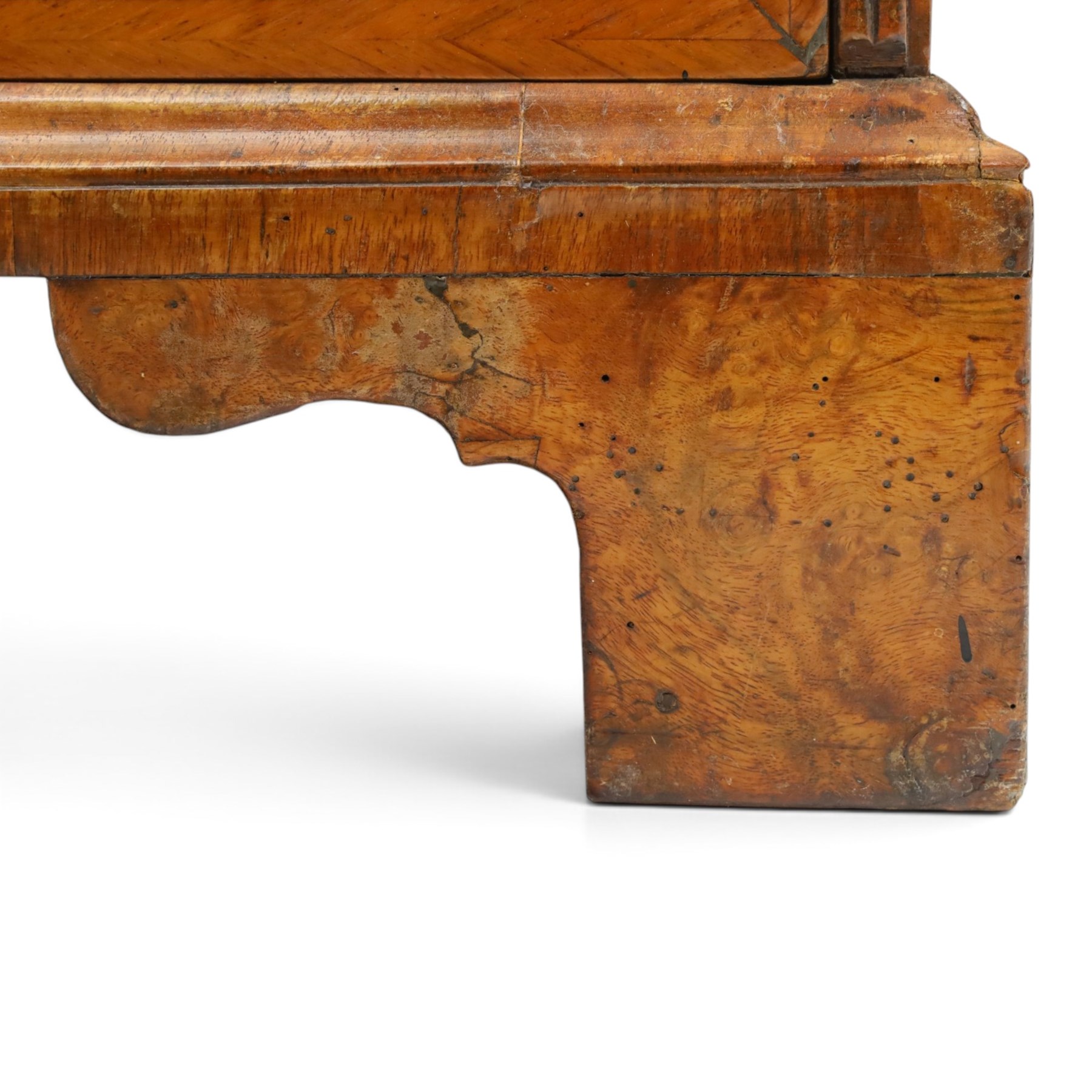 18th century figured walnut bureau, the sloped fall-front enclosing fitted interior with sliding base, pigeon-holes and correspondence drawers with shaped facias, over two short and two long feather-banded drawers with pressed brass handle plates, on bracket feet