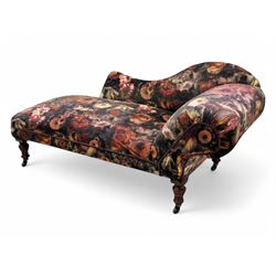 Victorian hardwood-framed chaise longue, serpentine back with rolled arm, upholstered in floral pattern fabric, on ring turned legs with ceramic castors 