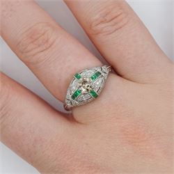 Platinum emerald and diamond ring, the principal transitional cut diamond of 0.41 carat, with milgrain set calibre cut emeralds and single cut diamonds surround and engraved foliate decoration shoulders, stamped Plat