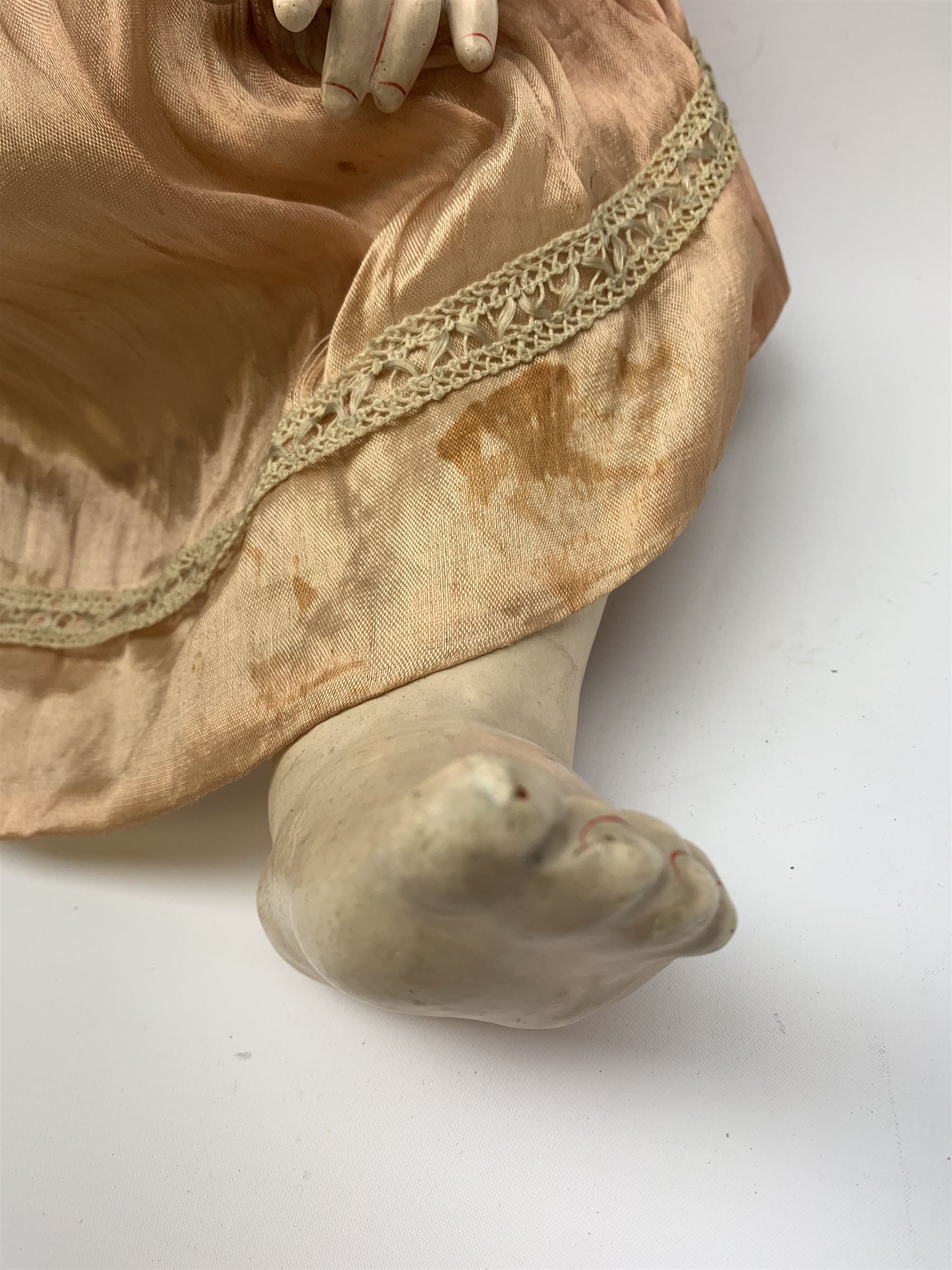 German bisque head doll with applied hair, sleeping eyes and open mouth with teeth and fixed tongue, on composition body with jointed limbs, marked 'P.M. 914 Germany 14' H65cm