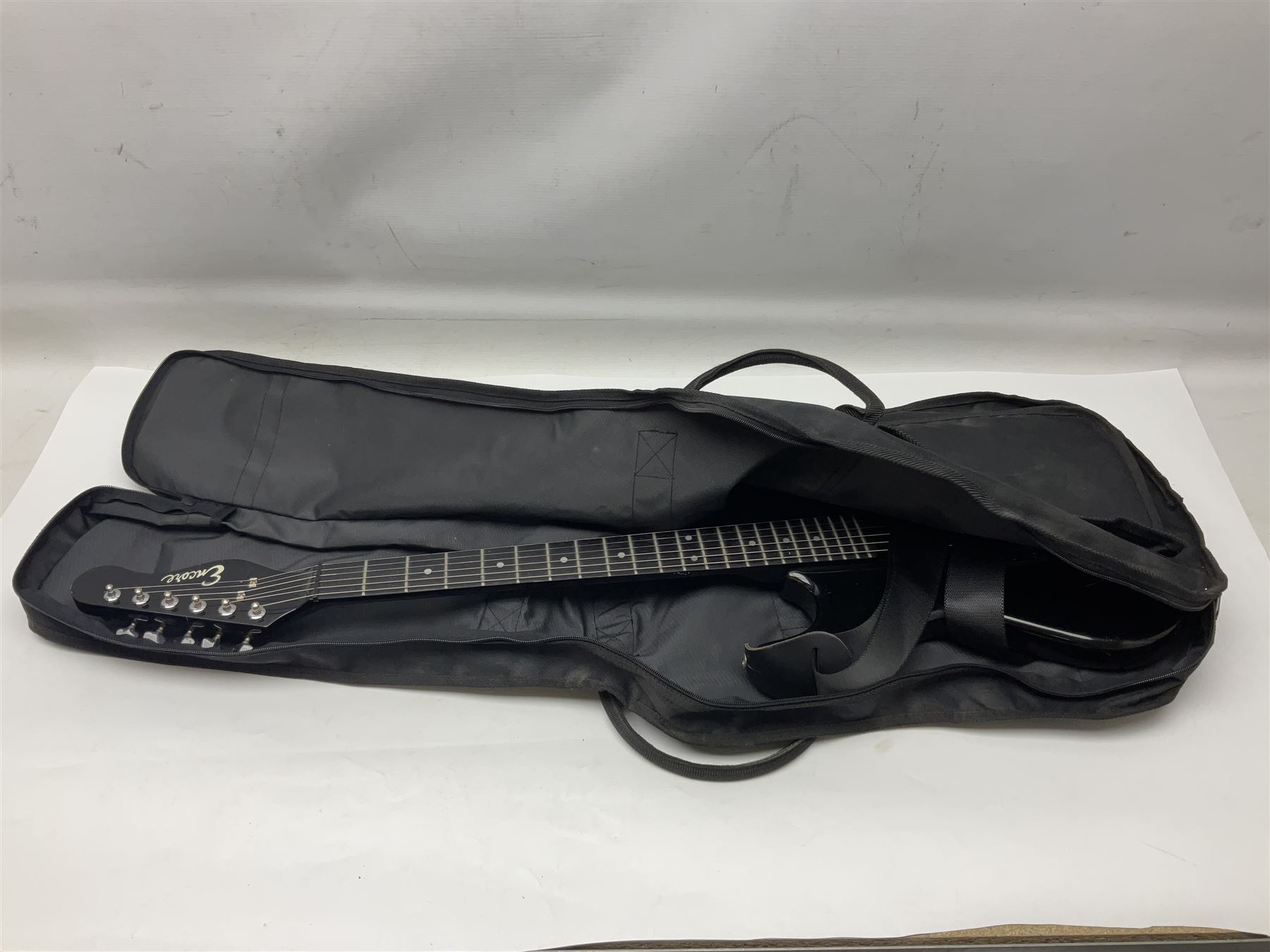 Encore black electric cut-away guitar L96cm; and Spanish Victor Garcia model 187 acoustic guitar, bears label dated 1972 L99cm; each in soft carrying case (2)