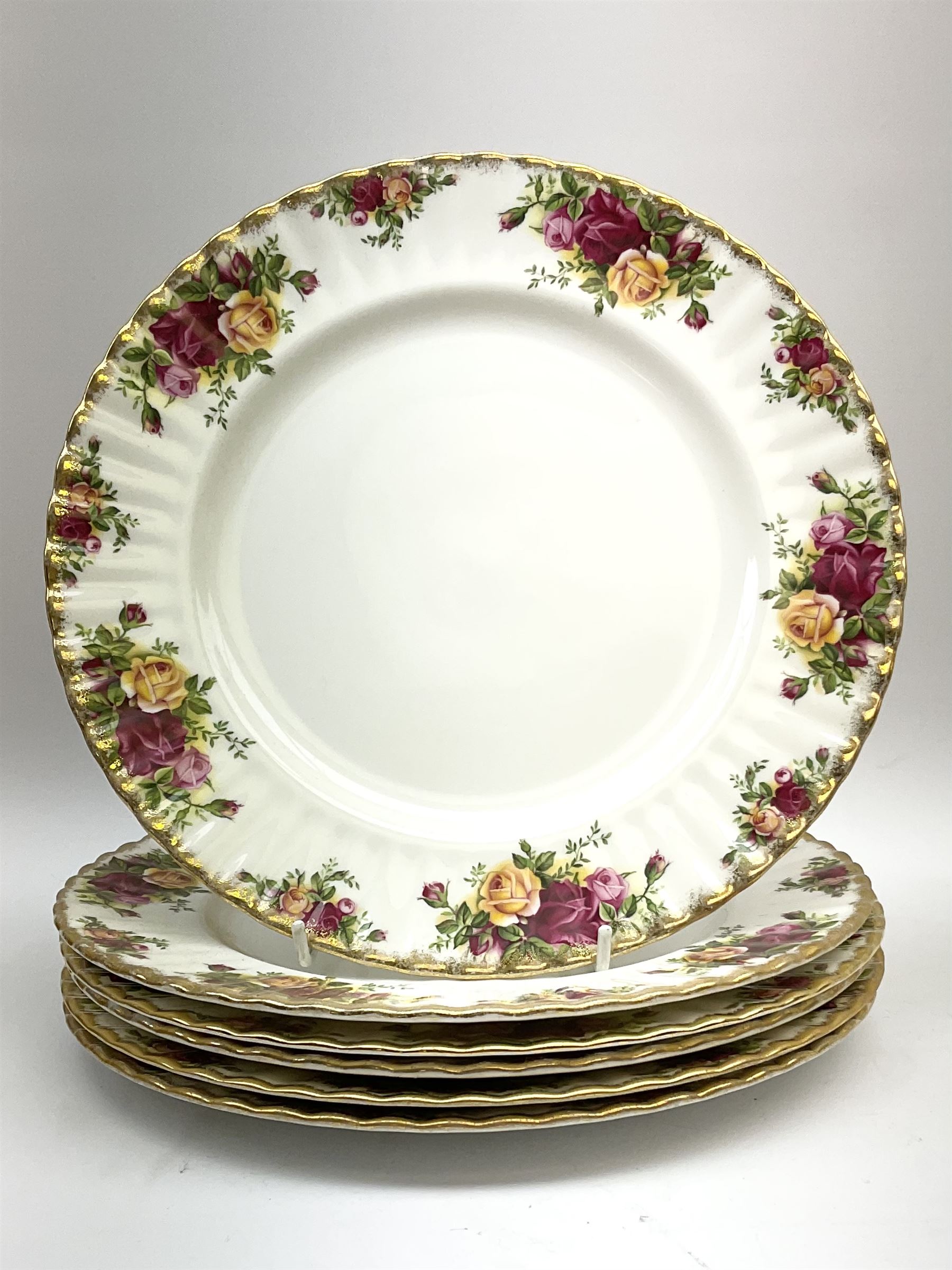 Royal Albert Old Country Roses part dinner and tea service comprising teapot, four tea cups and saucers, eight dessert plates, cake plate, cake stand, a tureen with cover, six dinner plates, an oval dish, two trinket dishes, bell and shoe decoration. 