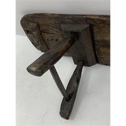18th/19th century and later large rustic oak plank bench on hewn trestle supports