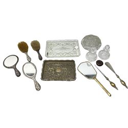 Glass dressing table tray, scent bottles and lidded bowl, metal mounted foliate design hair brushes and handheld mirrors etc