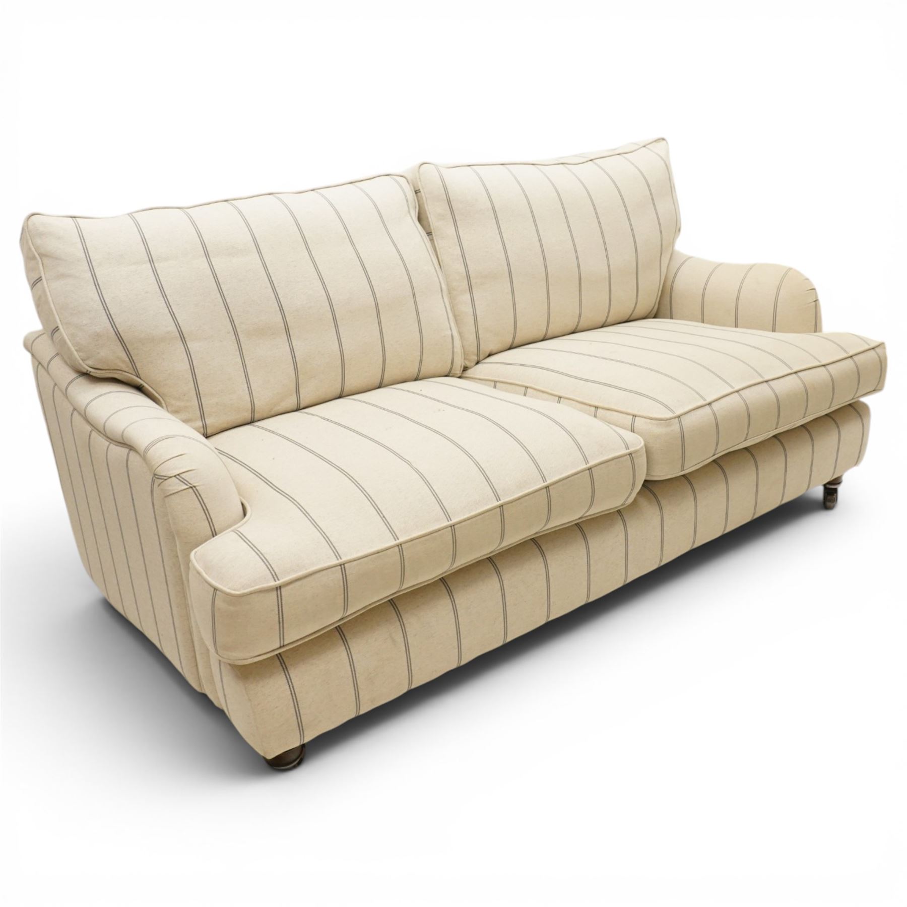 20th century Howard shape two seat sofa, deep seat sofa in cream and grep striped upholstery, raised on dark supports terminating in front castors 