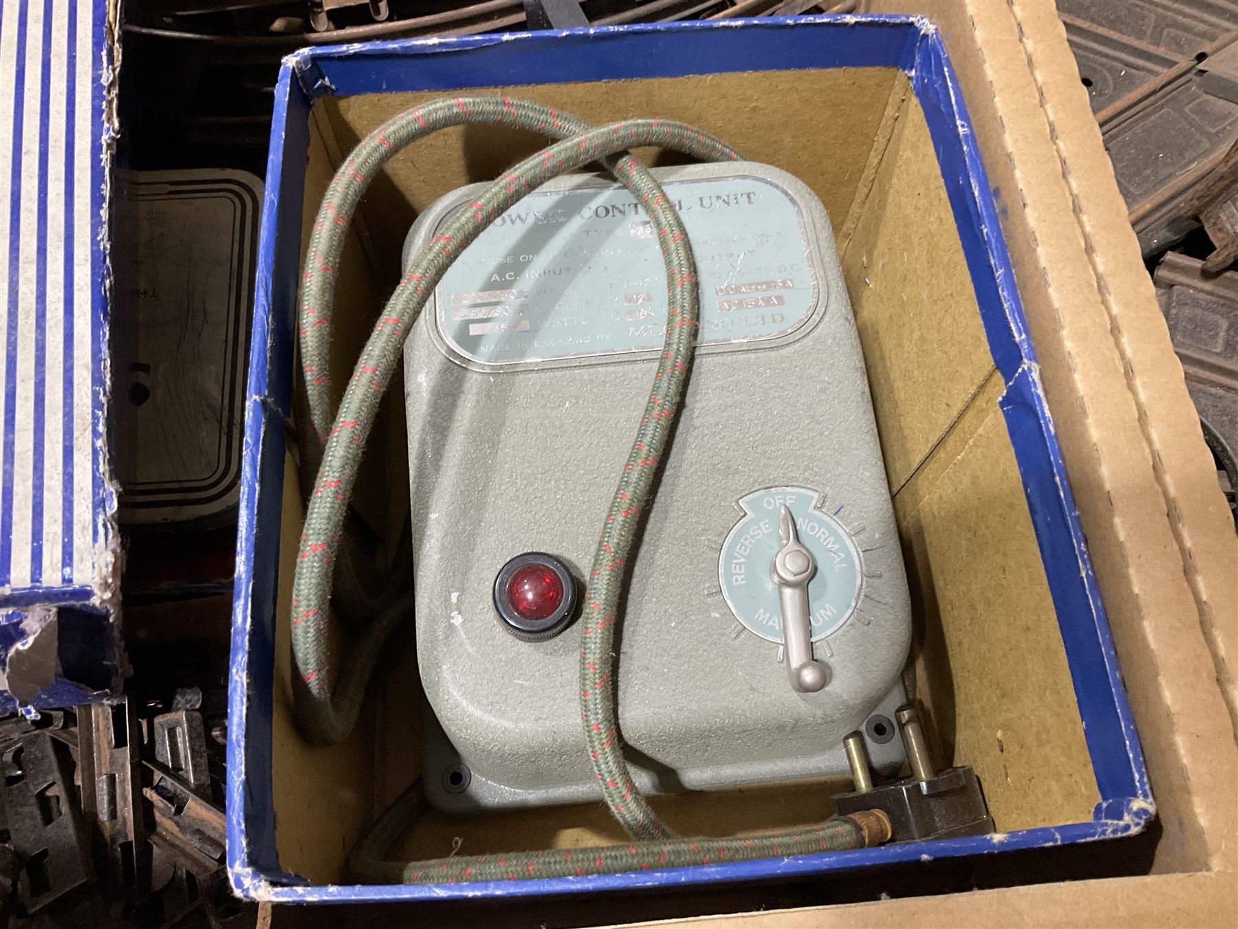 '0' gauge - large quantity of two-rail track with fixing clips including curves, straights, points, cross-overs etc; and boxed Meccano A3 Power Control Units; in four boxes