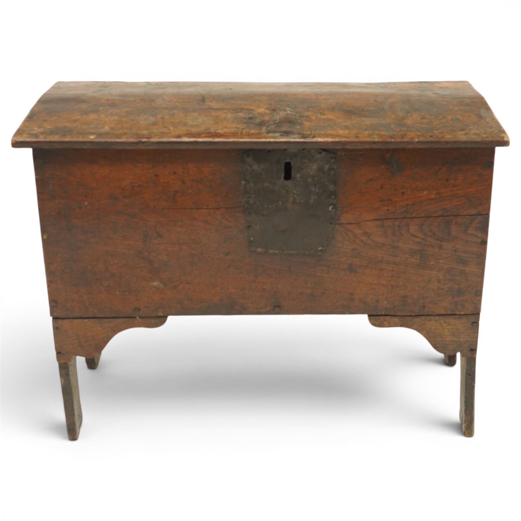 Small 17th century six plank oak coffer, figured top with iron pintle type hinges,  pegged boarded sides, large lock plate with rivets, plank ends continuing down as supports