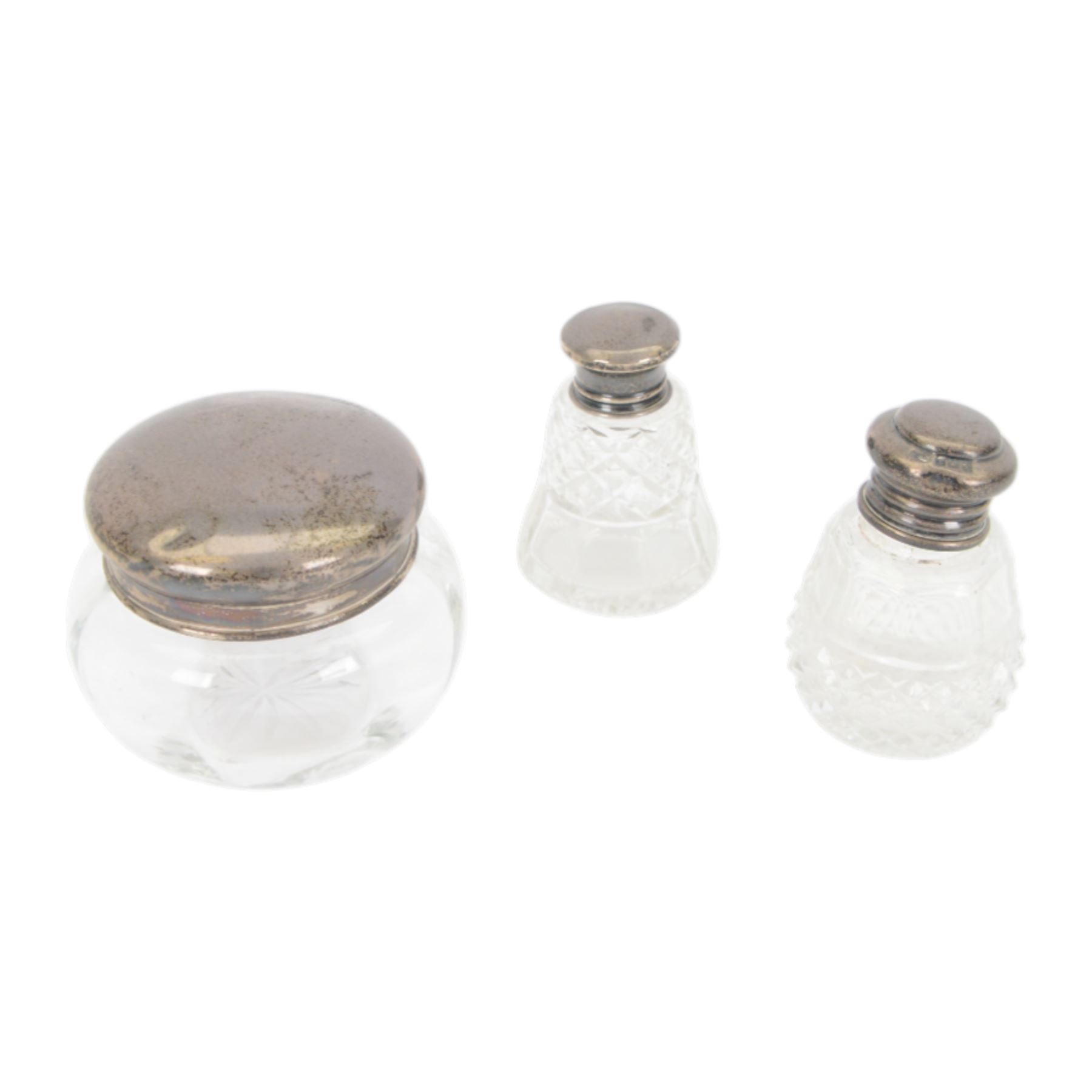 Collection of silver topped cut glass dressing table jars, together with a silver plated perfume bottle and large cut glass jar and cover