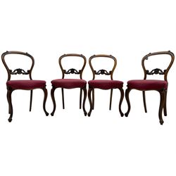 Set of six Victorian rosewood dining chairs, the balloon back carved with foliage scrolls, cartouche carved middle rail with extending scrolls, the seats upholstered in pink fabric, on carved cabriole supports with scrolled terminals 