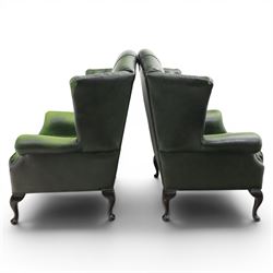 Thomas Lloyd - Pair of Queen Anne design wingback armchairs upholstered in buttoned green leather, button back and scrolled arms, raised on cabriole supports. 