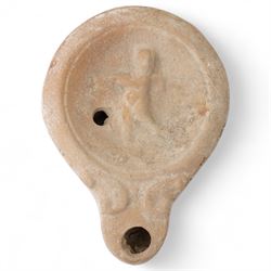 Roman terracotta oil lamp with Cupid motif c.1st–2nd Century A.D., mould-made, with a roun...