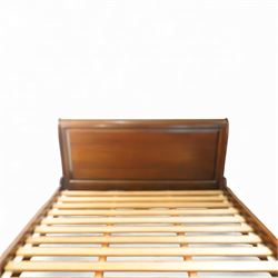 Late 20th century French design mahogany king size sleigh bed, the shaped headboard and footboard with scroll carved terminals and panelled fields, over swept side rails, raised on moulded bracket supports