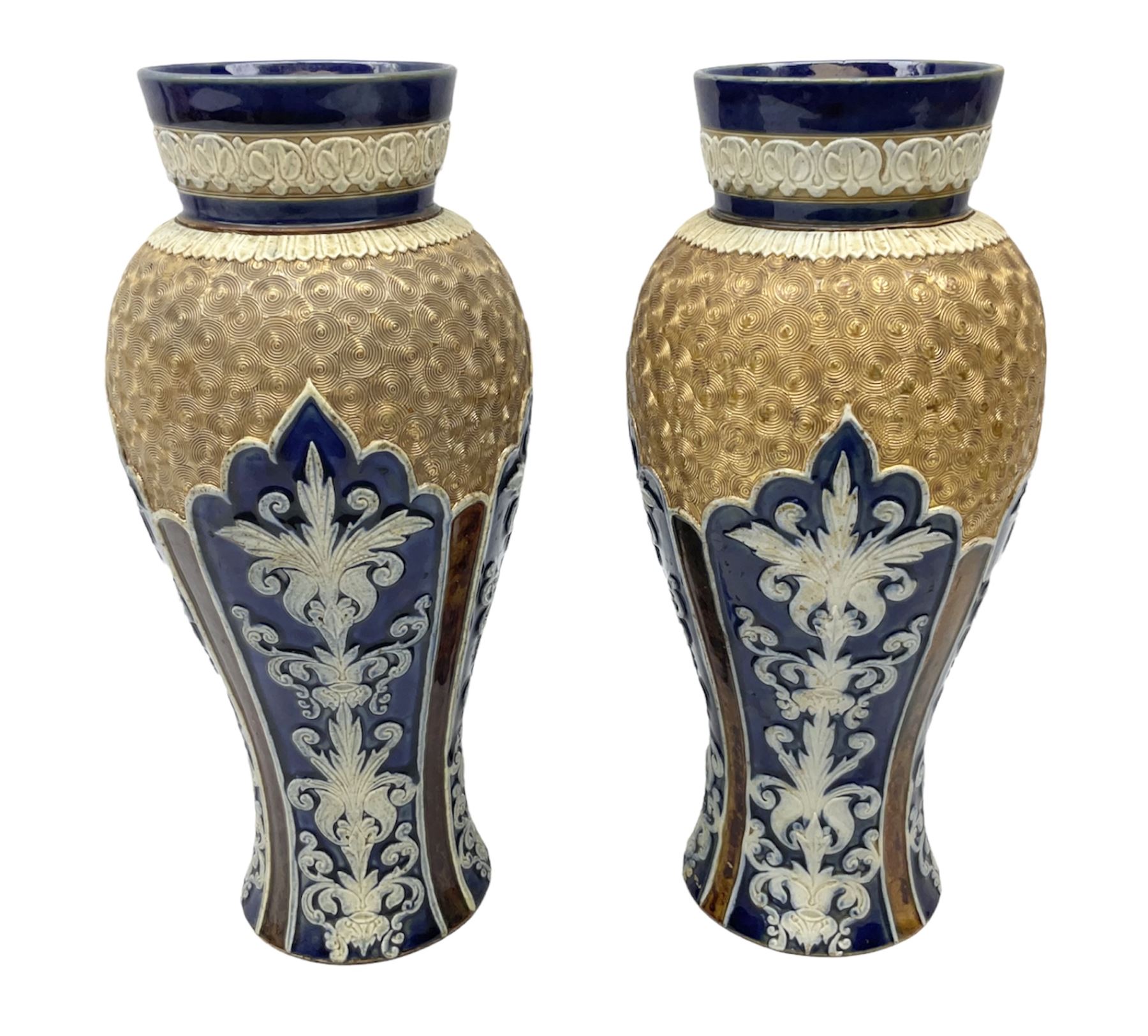 Pair of Royal Doulton Lambeth stoneware baluster vases, decorated in light relief with panels of foliage on blue ground, with gilt scrolls above, impressed mark beneath, 28cm high