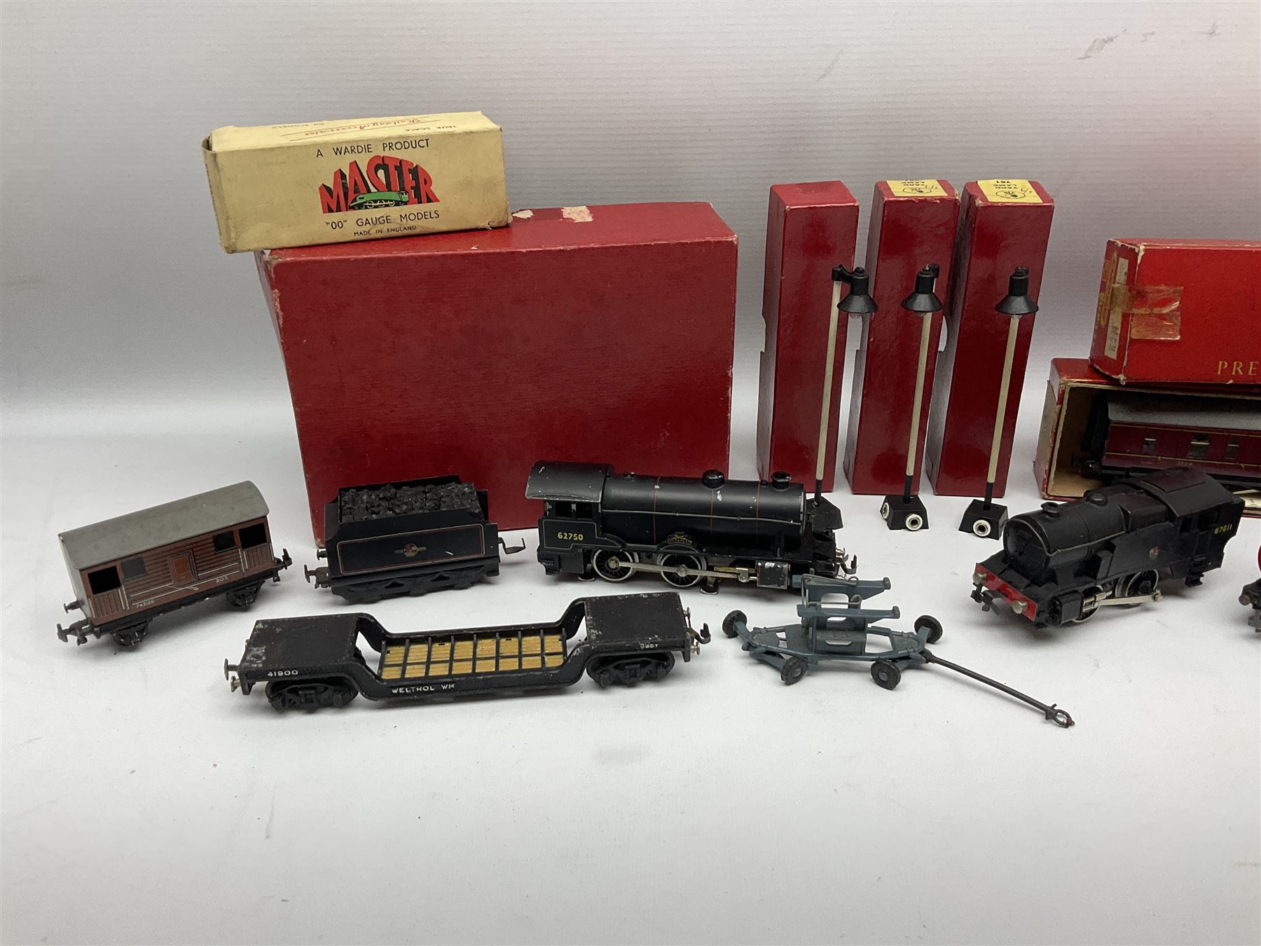 Trix Twin Railway - Hunt Class 4-4-0 locomotive and tender 'Pytchley' No.62750, boxed; 0-4-0 tank locomotive with plastic body No.67611; three passenger coaches (one boxed); six goods wagons; three boxed Yard Lamps etc; and Tri-ang Track Cleaning Car, boxed
