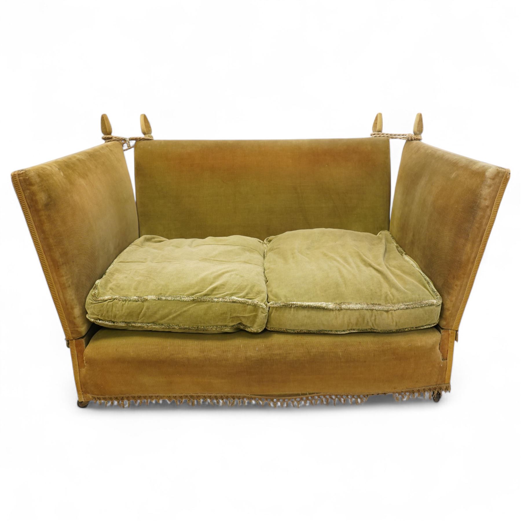 Mid-20th century Knoll style high back sofa, upholstered in olive green velvet with tassel fringe trim, sloped hinged arms and twin loose seat cushions, the frame surmounted by four finials