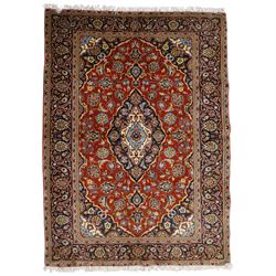 Central Persian Kashan hand-knotted rug, madder red field with central articulated cusped ...