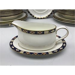 Royal Crown Derby dinner and tea wares decorated in the Kedleston pattern, comprising six dinner plates, twelve dessert plates, six side plates, six soup bowls, twelve fruit dishes, bread and butter plate, oval serving plate, oval serving dish, sauce boat and stand, cream jug, and two open sucriers 