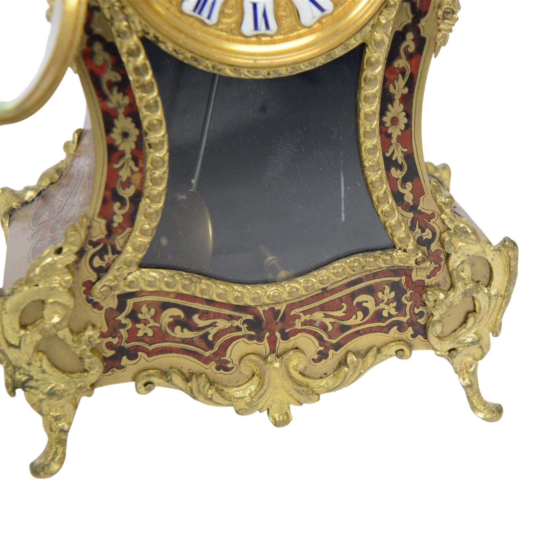 Louis XV-style gilt-bronze mounted turtleshell boulle mantel clock, the case of typical waisted form, gilt bronze foliate scroll and rocaille mounts, raised on scroll feet. Eight-day Paris movement signed “Rollin à Paris”, with outside count-wheel striking half-hourly on a single bell, the going train with anchor escapement. The circular foliate gilt bronze dial with enamelled Roman hour numerals and twin winding apertures, fitted with pierced blue steel hands and bevelled glass cover, with pendulum and key, circa 1860
