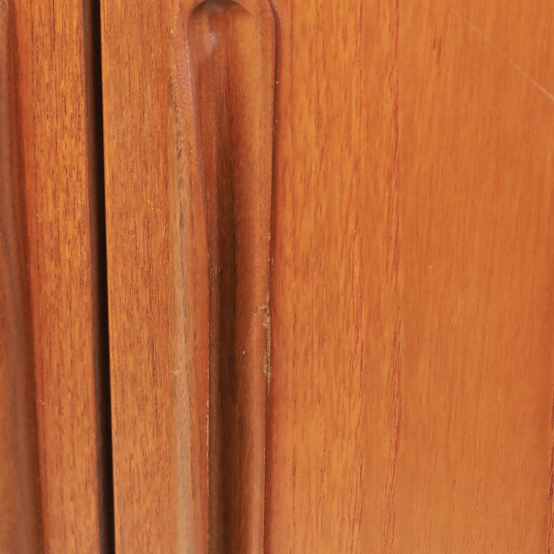 G Plan - 'Fresco' teak double wardrobe, twin doors enclosing a single clothes rail, on a recessed plinth base with castors beneath  