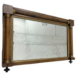 Early 19th century rosewood overmantel mirror, rectangular form with turned half pilasters, moulded gilt slip enclosing plain mirror plate, on turned feet