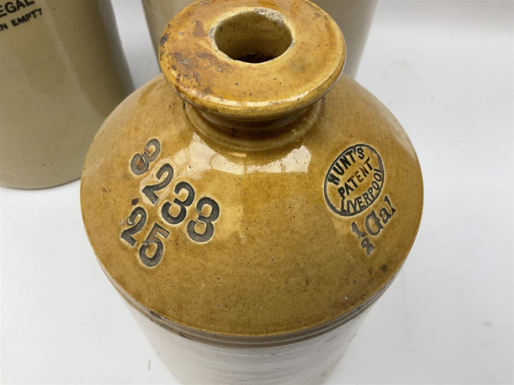 Four Hull stoneware flagons - Moors & Robsons Breweries Ltd H25cm, Hawkshaw Ltd Spencer Street Hull 1923, Triumph Herbal Brewery with brass dispensing tap and Texol Hull with screw stopper (4)  