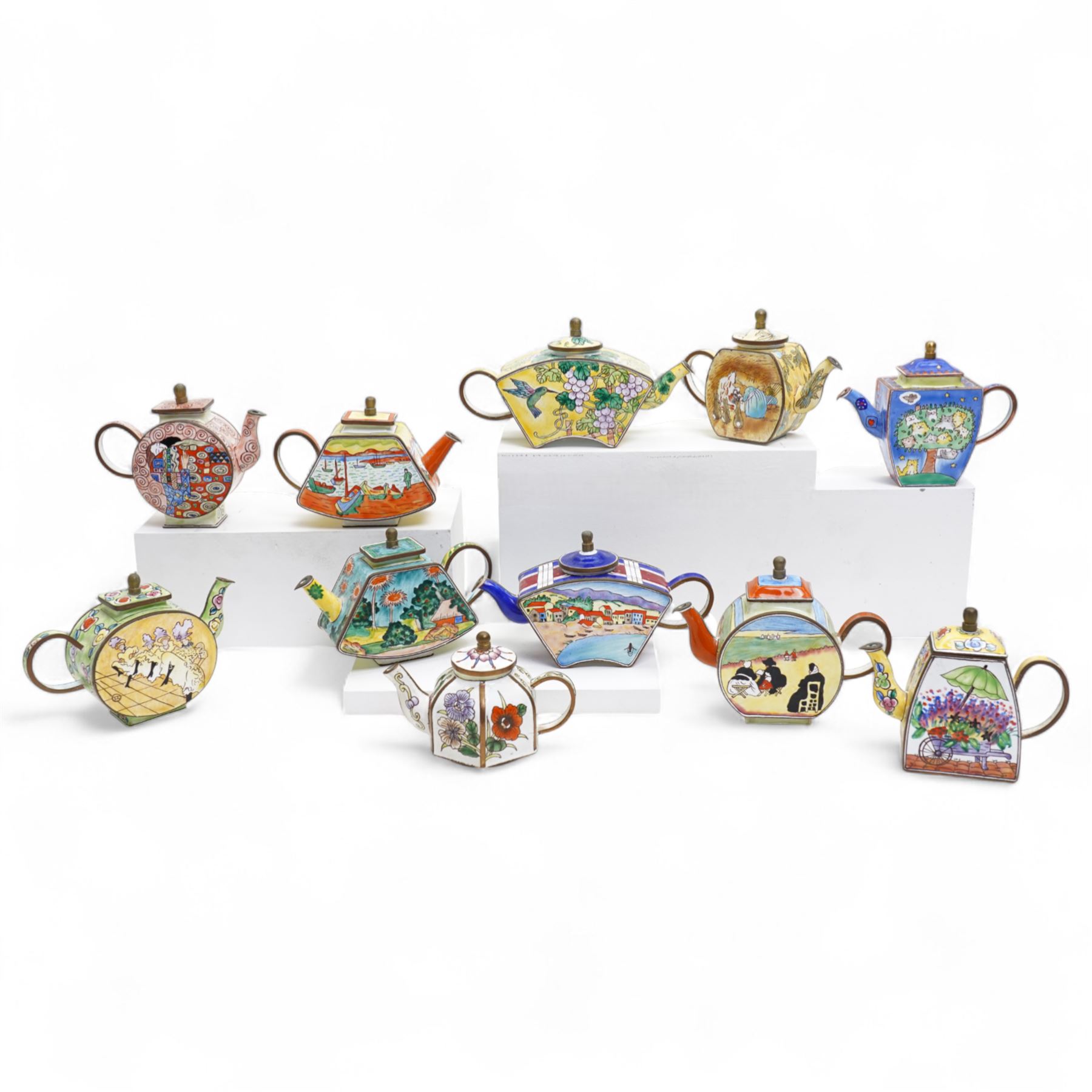 Ten Charlotte de Vita for Trade plus Aid miniature hand-painted enamel teapots, designs comprising The Kiss, Peter Rabbit, Dancing Girls, Catkins etc; and one other painted enamel teapot, largest H9.5cm (11)