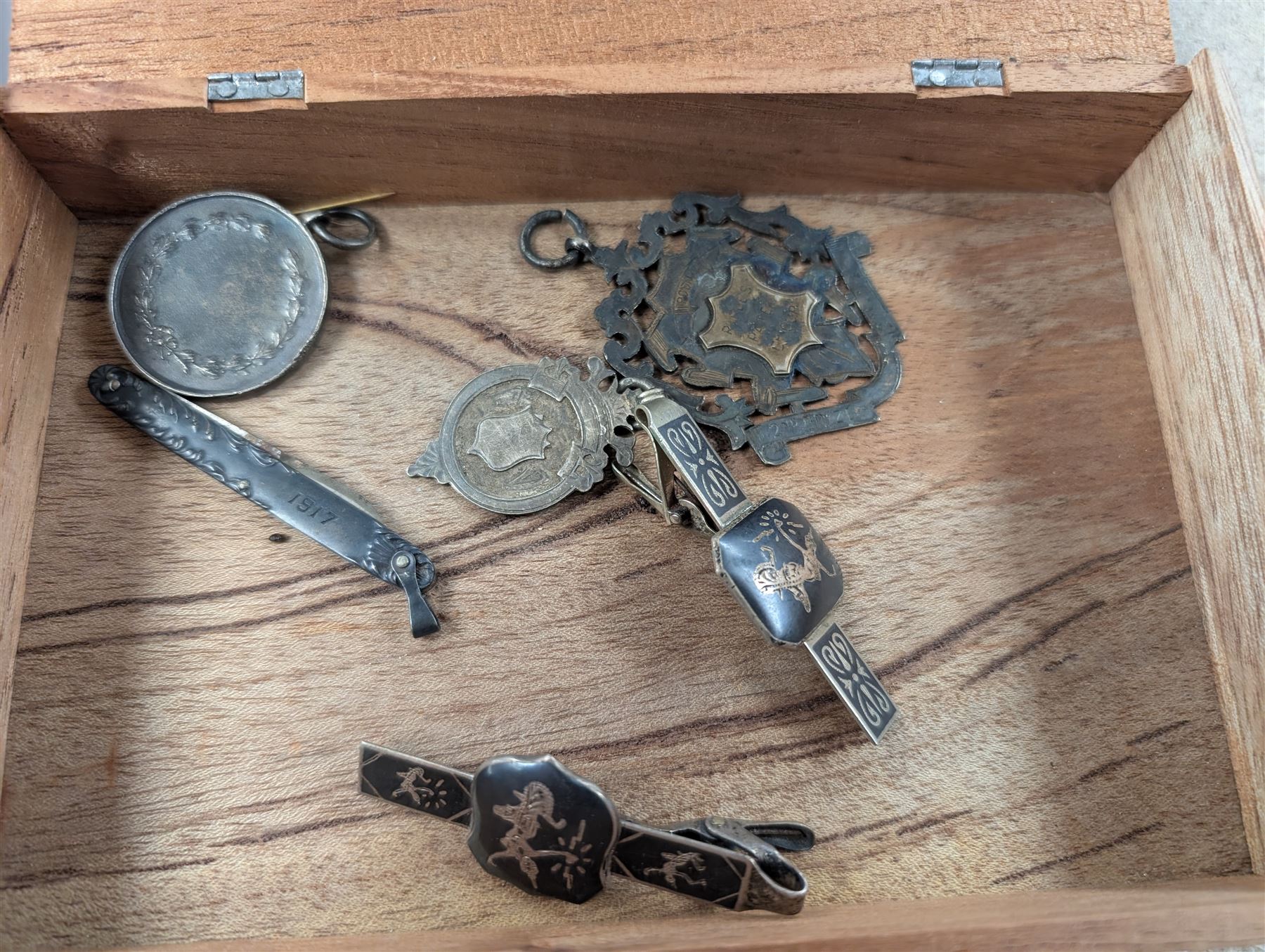 Collection of Great British and World coins, including 0.997 silver Laxmi Ganesh Krishiiamahavir Ambajishrinathji coin, American coins, commemorative coins, etc together with a silver fob medal, two Siam silver tie clips and a silver pen knife inscribed 1917